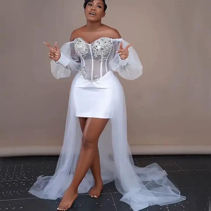 Robes de mariée blanches pour mariée, Robes de mariée africaines, épaules dénudées, manches longues, haut et bas, avec des Appliques en cristal argenté, personnaliséesRobes de mariage blanches pour ma