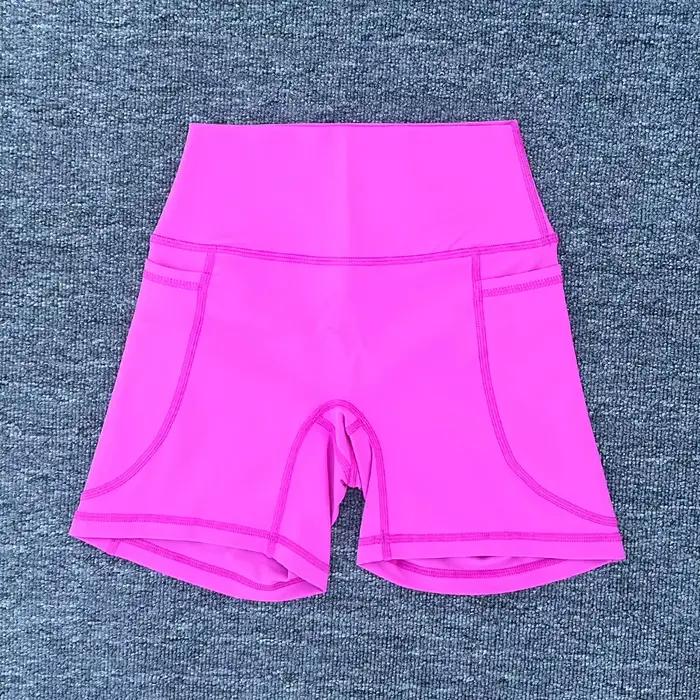 Shorts sportifs pour femmes en nylon et élasthanne avec poche droite pour yoga et fitness