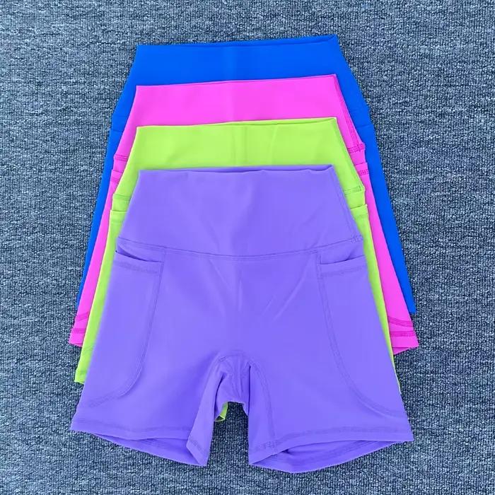 Shorts sportifs pour femmes en nylon et élasthanne avec poche droite pour yoga et fitness
