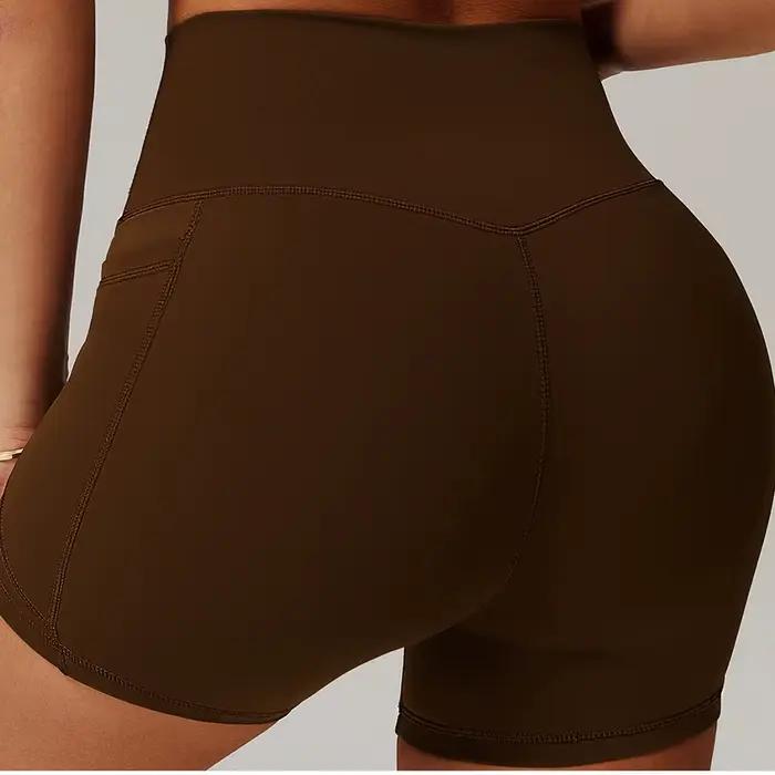 Shorts sportifs pour femmes en nylon et élasthanne avec poche droite pour yoga et fitness